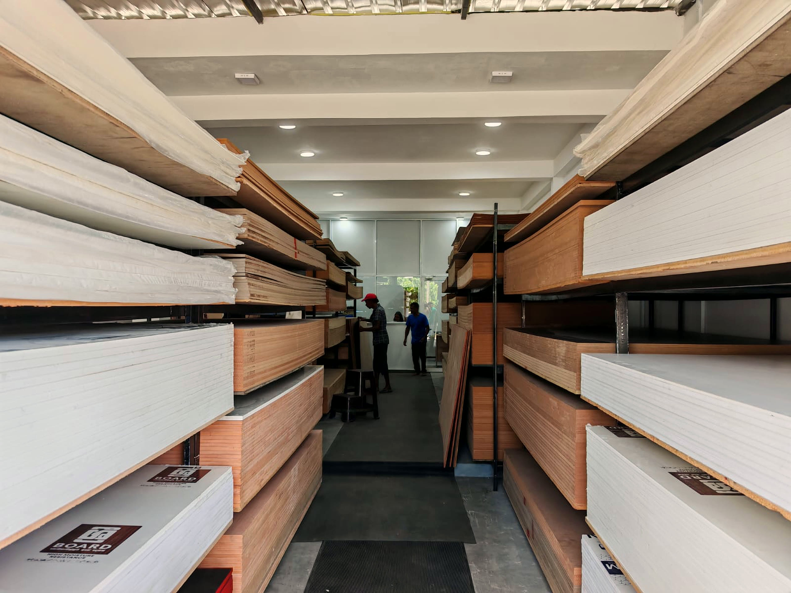 Staff serving at the trade counter at the end of the board aisle.